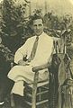 Reid seated near his golf clubs, c. 1926