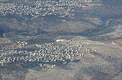 Az-Zawiya seen in the back, while neighboring Rafat is seen in front