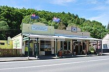 Two old storefronts with large facades