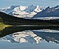 Looking north at Parka Peak centered with Atna Peaks to left reflected in a lake near Donoho Peak