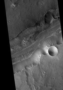 Bahram Vallis, as seen by HiRISE. Rotational landslides (slumps) are visible at the base of north wall