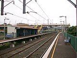 Lysaghts railway station, in Australia, with two side platforms and a footbridge connecting them.