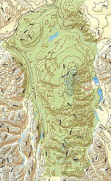 A yellow and green map with contour lines depicting a mountainous environment.