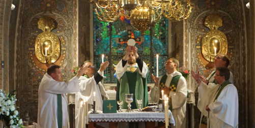 Lutheran priest elevating the host during the Mass at Alsike Church, Sweden