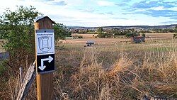 Direction sign regarding a hiking trail in Ebsdorfergrund, Hesse, Germany