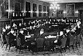 London Conference, St. James' Palace, February 1939. Palestinian delegates (foreground), Left to right: Fu'ad Saba, Yaqub Al-Ghussein, Musa Alami, Amin Tamimi, Jamal Al-Husseini, Awni Abdul Hadi, George Antonius, and Alfred Roch. Facing the Palestinians are the British, with Sir Neville Chamberlain presiding. To his right is Lord Halifax, and to his left, Malcolm MacDonald.