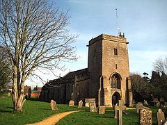 Stone building with square tower.