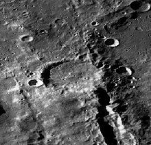 An image of Vallis Planck getting distupted by the Fechner Crater as it travels northwest