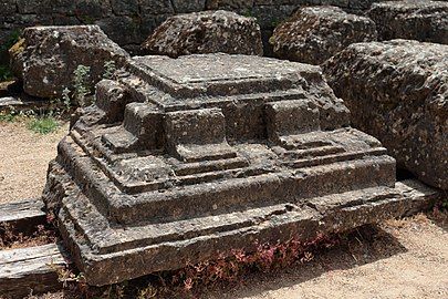 Photo of a carved corner stone on the floor.