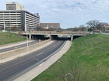 A view of Interstate 375, showing both carriageways of the freeway and an overpass with a sign for Larned Street.