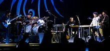 Dylan together with five members of his band onstage.