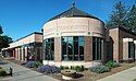 A one-story, at-grade building with a corner rotunda