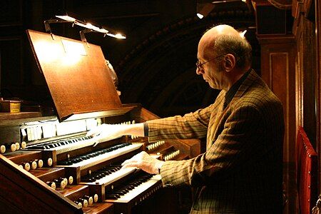 François-Henri Houbart, the current organist in 2022, at the keyboard in 2011