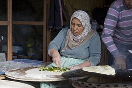 Gözleme, a filled bread, being baked on a sac