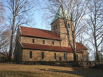 Old Aker Church, Norway, has a very large tower dividing the nave from the chancel.