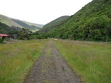 A long trail through a grassy hilly terrain