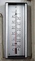 Thermometer with a scale in Celsius and Kelvin Scale attached to one of the pillars of the church