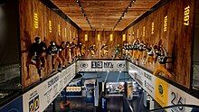 Photo from the second floor of the Packers Hall of Fame looking down the stairs with various exhibits showing