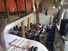 The staff of Mother care sitting for a sermon.