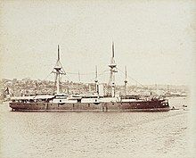 A large black warship with two tall masts