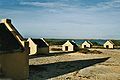 Image 13The forced African migrants brought to the Caribbean lived in inhumane conditions. Above are examples of slave huts in Dutch Bonaire. About 5 feet tall and 6 feet wide, between 2 and 3 slaves slept in these after working in nearby salt mines. (from History of the Caribbean)