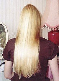 An adult woman with blond hair; back facing the camera