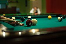 A player is preparing for a shot in 8-ball