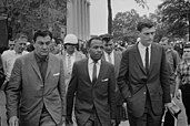 Meredith (center) being escorted to class after the riot