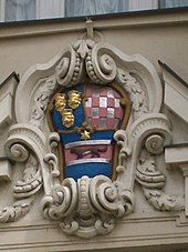 Shield with colored painting on stone building