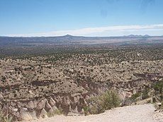 Tent rocks, with Cochiti Pueblo lands and the Rio Grande in the distance