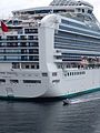 The back of the Sapphire Princess in Ketchikan with a small raft giving an idea of the scale.