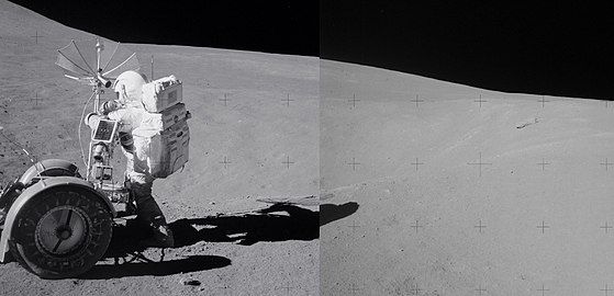 Spur crater in background, with astronaut David Scott at left next to rover. The breccia boulder is at right in the distance.