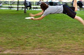 Sage Ross leaping after a frisbee.