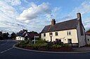 ☎∈ A house on Cambridge Road and village sign in Littlebury in July 2012.