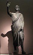 The Orator, c. 100 BC, an Etrusco-Roman bronze statue depicting Aule Metele (Latin: Aulus Metellus), an Etruscan man wearing a Roman toga while engaged in rhetoric; the statue features an inscription in the Etruscan alphabet