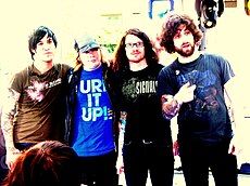 Fall Out Boy standing still while posing for a camera.