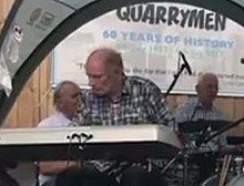 A man playing an electric keyboard on a stage