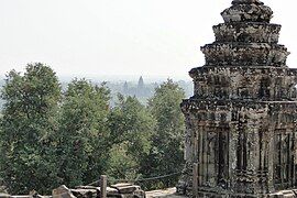 Stone tower and Angkor Wat far afield