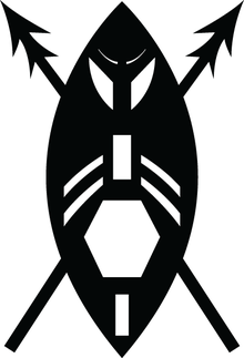 A black and white image of a stylised version of an African shield as a warrior's face with two crossed spears. The shield is encompassed by two circle arcs with white geometric shapes as cut-outs: rectangle at bottom, a larger hexagon (in the position of the mouth), another rectangle (in position of the nose) with two pairs of curved strips (as moustaches), two larger curved sections (in position of the eyes) and two small curved strips (as eyebrows). The spear heads are double pointed.