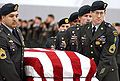 A casket team from the 1st Special Forces Group carry the flag-draped casket of Sergeant 1st Class Nathan R. Chapman on January 8, 2002, at Seattle-Tacoma International Airport.