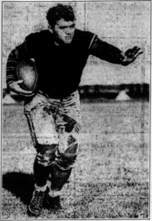 A black and white photograph of an American football player from the 1920s