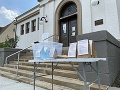 Children's programming kits being displayed and offered on the sidewalk in front of the Mt. Washington branch