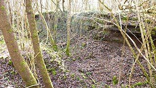 A truncated slag mound shows its layers