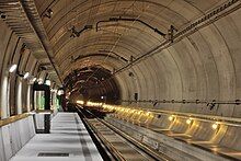 Ballastless track of the type "Low Vibration Track" with rails fixed to concrete sleepers that are set in a concrete slab in the Gotthard Base Tunnel's Sedrun multifunction station.