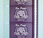 Vertical section of filmstrip, showing four-and-a-half frames, each of which reads, "Sea Power for Security. The End." Alongside the frames runs a continuous vertical white band of continuously fluctuating width.