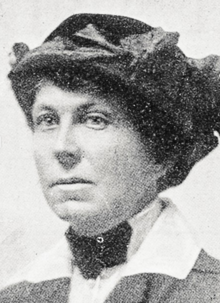 Photograph of a white woman wearing a dark hat; from a 1918 newspaper.