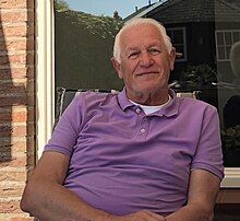 Hans Hoogveld sitting in a purple shirt