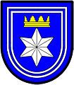 a double tressure—Azure; a facetted six pointed star [mullet] argent ensigned with a gable crown or, the whole within a double tressure argent—Langenhoven, RSA