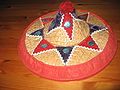 A decorative Assamese jaapi constructed with bamboo while the decorations are felt, threads and tin glitter