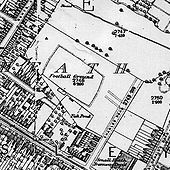 map shows football ground with housing to west and south and farmland to north and east